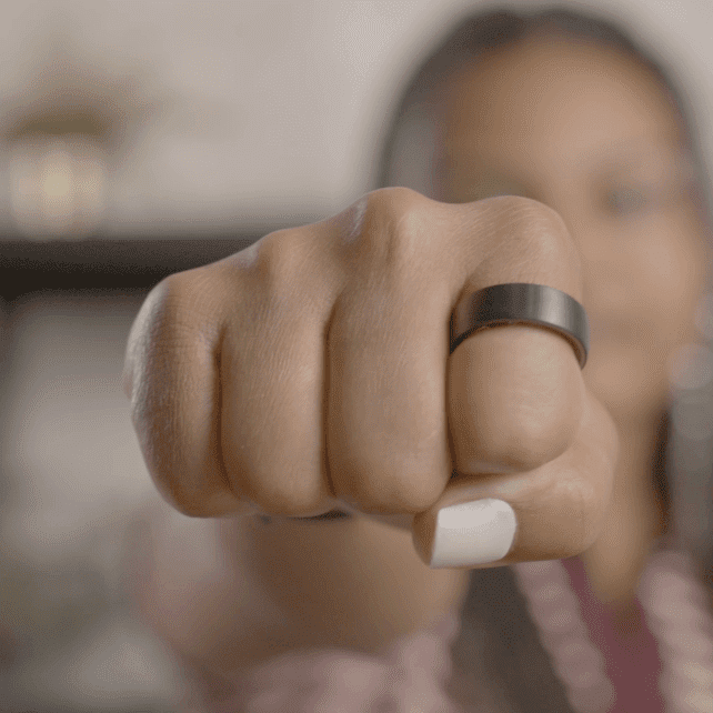 Dłoń z czarnym smart pierścieniem używanym do płatności zbliżeniowych